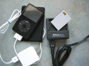 A photograph shows an MP3 player connected to its recharger and the cell from a camera being placed into its recharger.