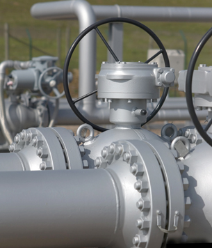 A photograph shows a close-up of many grey-coloured, high pressure pipes in an outdoor location.