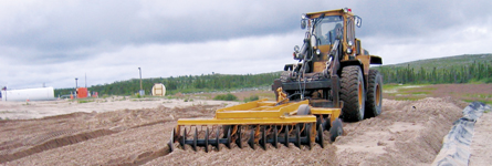 A photograph shows a tractor turning soil by dragging a rake.