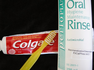 A photograph shows a toothbrush, toothpaste, and a dental rinse containing fluoride.