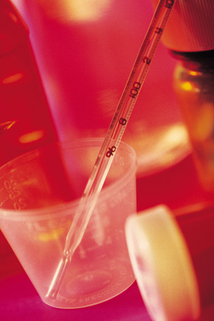 A photograph shows a pipette and other glassware for doing chemical analysis, and a cup used to measure prescription drugs.