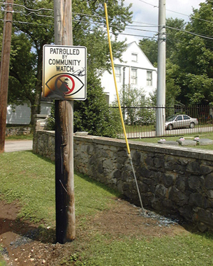 The photo shows a power pole that was hit by lightning the night before. The lightning transformed sand near the base of the pole into glass.
