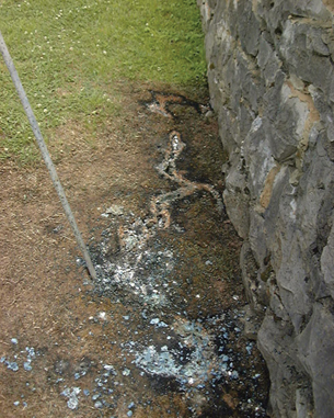The photo shows close up details of the glass formed in the sand at the point where the guy wire enters the ground.