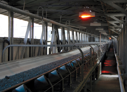 A photo shows a conveyor that is used to transfer coal to a boiler.