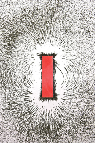 A drawing shows a red bar magnet with iron filings around it. The formation of the iron filings around the bar magnet shows the magnetic field around the bar magnet. 