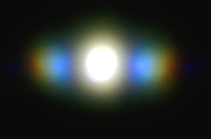 A photo shows a visible light spectrum produced by a diffraction grating.