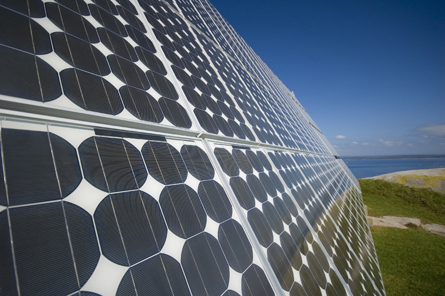 A photo shows a long panel of solar cells. Solar cell technology uses the interaction of photons and metals to convert radiation energy into electrical energy.