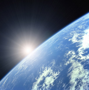 A photo from space shows the sun appearing above the curve of Earth’s surface. Up close, Earth’s atmosphere is only a thin layer surrounding the planet.