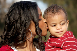 In this photo a parent or guardian kisses her child goodbye.