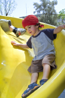 A child goes down a slide in this photo.