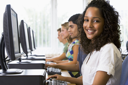 A photograph shows students working at a row of computers.