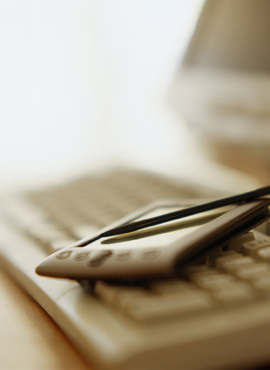 Image of a PDA device lying on a keyboard