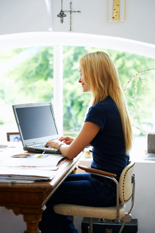 Image of a woman sitting at a computer workstation.