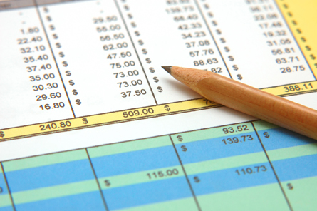 This is an image of a printed spreadsheet with a pencil lying on it.