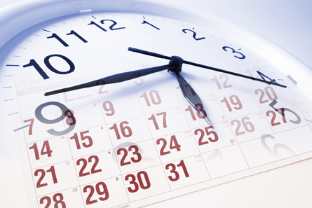 This is an image of a calendar and a clock faded together.