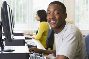 A picture shows two students working in a computer lab.