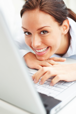 This is a photograph of a young woman with a laptop.