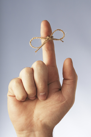 A string tied around a finger for remembering.