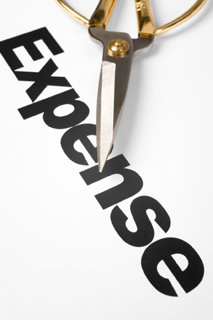 Scissors cutting the word Expense 