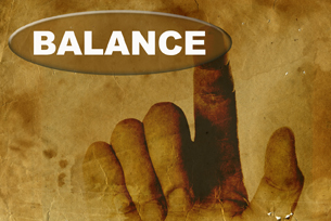 A finger pointing to the word Balance.