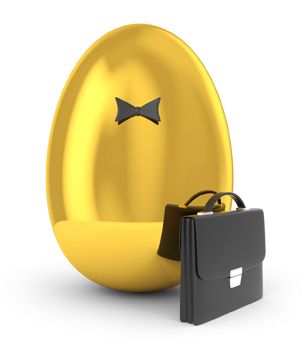 This photo shows a golden egg dressed as a businessperson with a briefcase.