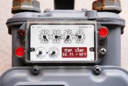 This photograph shows a gas meter with dials.