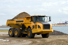 This photograph shows a large truck loaded with sand.