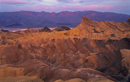 This is a photo of a rugged, orange-red mountain scene.