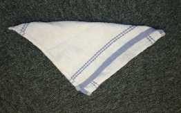 This photograph shows a square cloth folded in two to make a triangle.