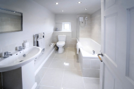 This is a photograph of a bathroom with a small window.