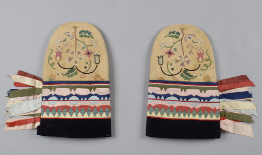 This is a photograph of a pair of intricately beaded mittens made by a Cree artisan.
