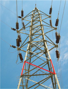 This illustration shows a four-legged electrical tower, which tapers inward as it rises. A zed shape is drawn over the photo. The shape runs along one leg of the four-legged tower, down along one cross-brace, and up another leg of the four tower legs.