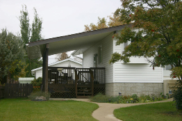 This illustration shows a covered deck attached to a house. The side of the deck is parallel to the side of the house.