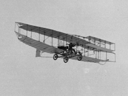 The photo shows the Silver Dart in flight.