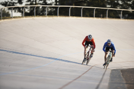 In this photograph two cyclists are competing on a cycling track.