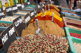 This is a photo of containers full of spices in the bulk-foods section of a store.