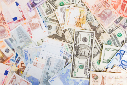 A photo shows many different types of currency.