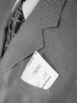 This is a photo of a businessman with an earnings statement in his pocket.