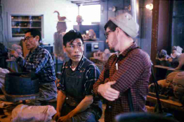 This is a photo of Inuit artists collaborating at a pottery co-operative.