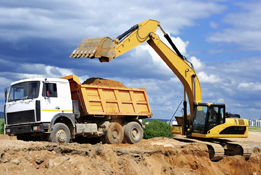 This photo is of a gravel truck and loader.