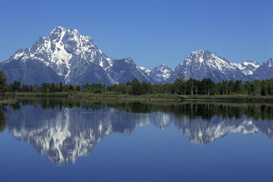 This is a picture of mountains reflecting in a lake.