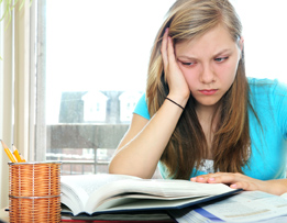 This is a photo of a teenage girl frustrated with her homework.