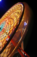 The photo shows a Ferris wheel in full spin.