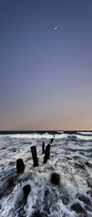 This photo shows moon rise over surf
